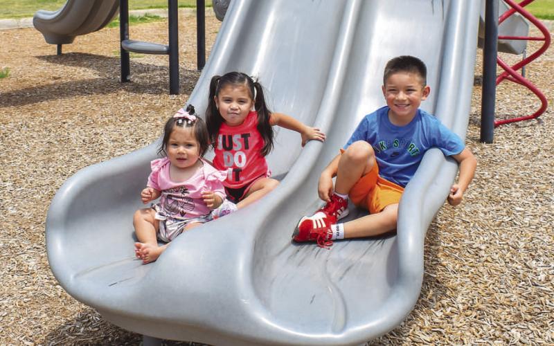 SUMMER FUN- Pictured are siblings Annalise Perez, Rosalyn Torres and Xavier Perez enjoying the cooler weather at the Levelland City Park on Tuesday. (Photo courtesy of Emily Campos)