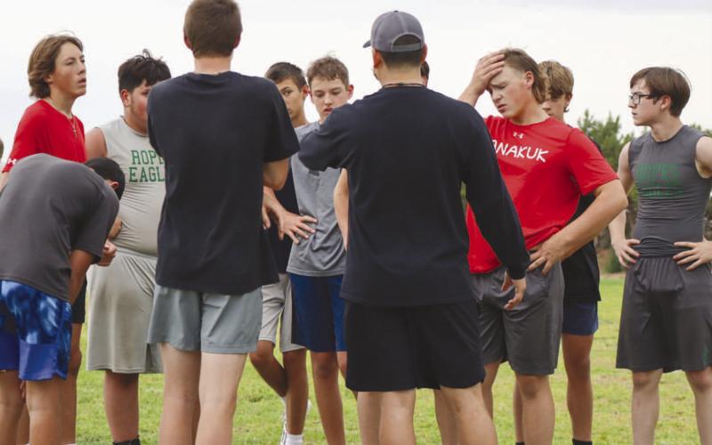 HUDDLE UP - The older group of kids huddled around Coach Joey Ybarra during the Ropes Eagle Football Camp this past Monday at the Ropes Football Field. (Staff photo by Aalijah Soliz)