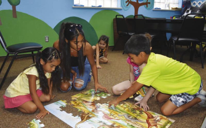 PUZZLING – Pictured are participants in Wednesday’s summer reading activity at the Hockley County Memorial Library. It was a smaller activity with board games and indoor fun. (Staff photo by Ada Niederhauser)