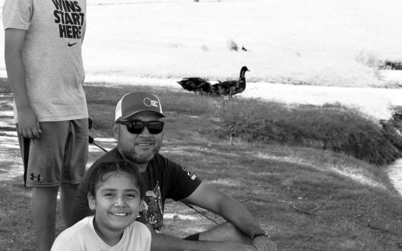 CATCHING FISH - Levelland’s David Olivo enjoyed his time off work and spent the day fishing at Lobo Lake with his children Ian Olivo and Lexi Olivo. With over 13 parks within the City of Levelland, community members can take advantage of the fun activities each park has to offer including fishing at Lobo Lake and at Brasher Lake. In addition to fishing, both parks have walking trails and playground equipment for children. (Staff photo by Emily Campos)