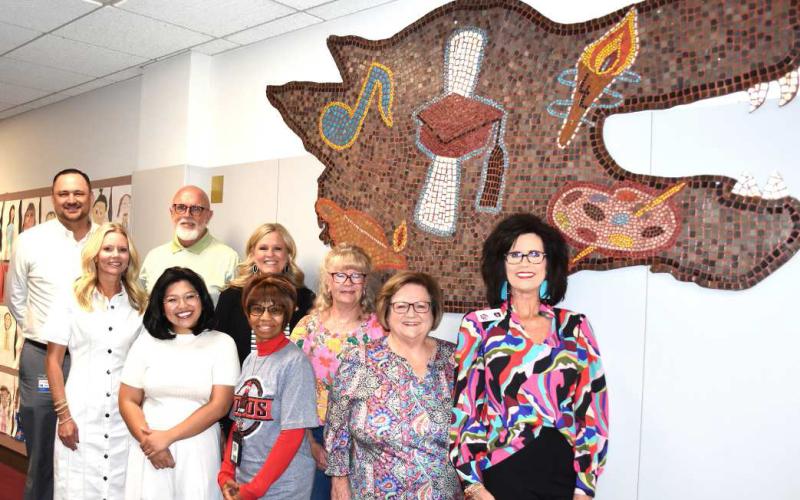 MOSAIC’S NEW HOME-- Levelland ISD on Thursday moved the 1975 Lobo mosaic on Thursday. It now has a new home after being mounted at the Levelland ISD Central Office on 704 11th St. Joining LISD administration for the relocation were 1975 juniors Margarett Dailey-Locket and Rhonda Bradley. (Staff photo by Lynda Work)