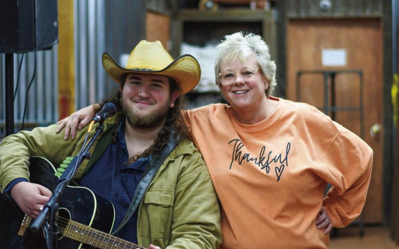 SINGING THE NIGHT AWAY - During the Main Street Ladies Night Out Event last Thursday, Austin James, a traveling singer from the New Braunfels area provided live music at Our Stuff located in downtown Levelland. Pictured along side James is Shanna Saunders who is the owner of the local business. (Staff photo by Myra Guerrero)