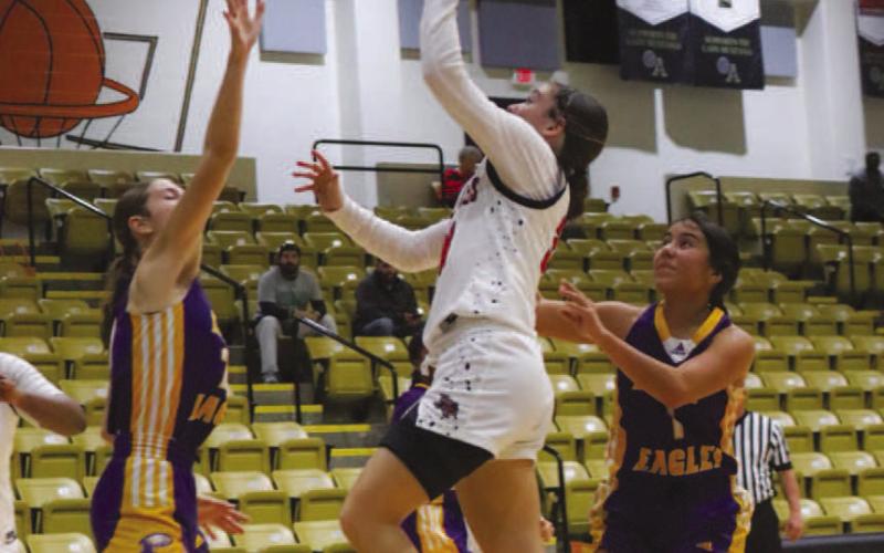 TOO SMALL - Levelland Loboette Presley Smith layed the ball up over two Pecos defenders during the team’s contest in the Andrews Tournament this past Thursday. (Staff photo by Aalijah Soliz)
