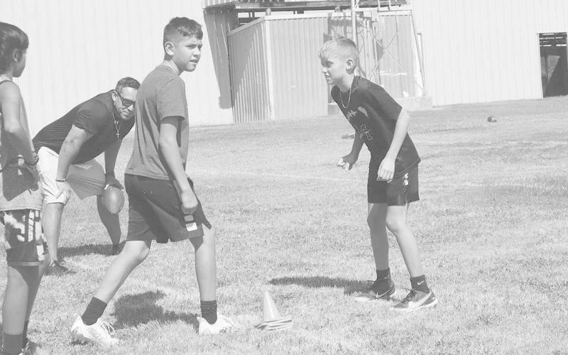 GOOD STANCE - Morton athletes Aidyn Ramirez and Alrian Alvarado were lining up on the line to show proper techniques and stances to get off the ball quicker in Monday’s camp workout during the annual Morton ISD Football Camp. The Morton coaching staff focused heavily on the basics and fundamentals of the game to ensure the kids had no bad habits during their drills. (Staff Photo by Aalijah Soliz)