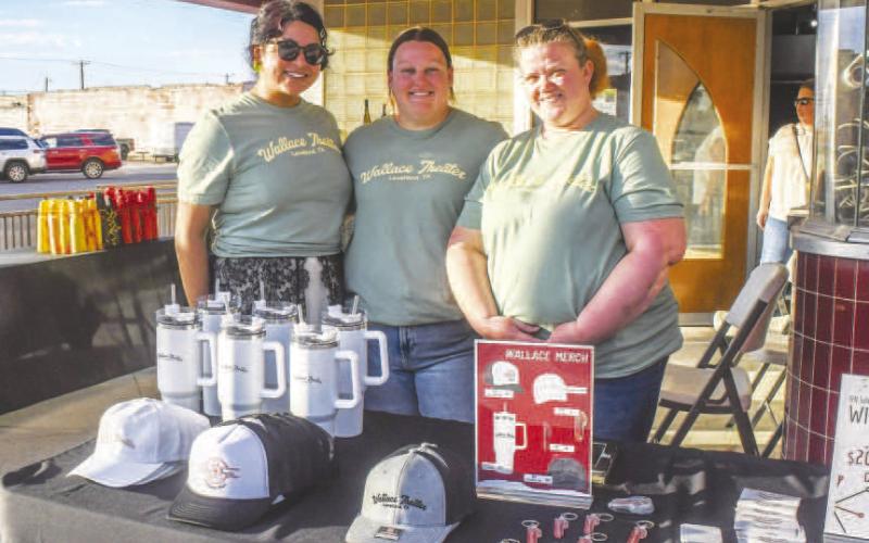 Arlette Silva, Jolenna Carter and Tina Wiiest smiled in front of Wallace Theater’s booth at Sip and Swirl on Friday evening, serving up wine, food and merchandise to attendees at the event. (Staff photo by Evin Thomas)