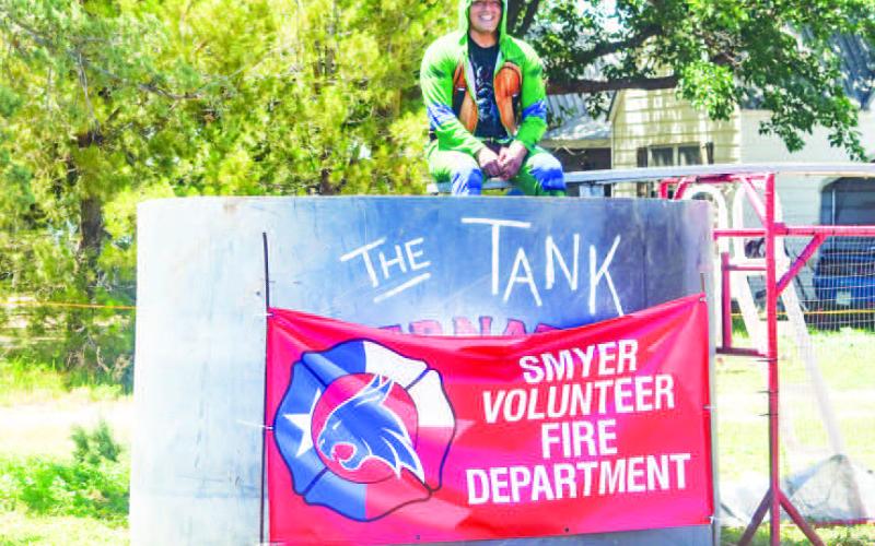 DUNK TANK - On Saturday, at the Smyer VFD Fundriser, the fire department set up a dunk tank. Pictured is Fire Fighter Joshua Flores dressed in a turtle outfit waiting for some one with a good aim to cool him off. There was also a cornhole tournament and a car show contest.(Staff photo by Emilly Campos)