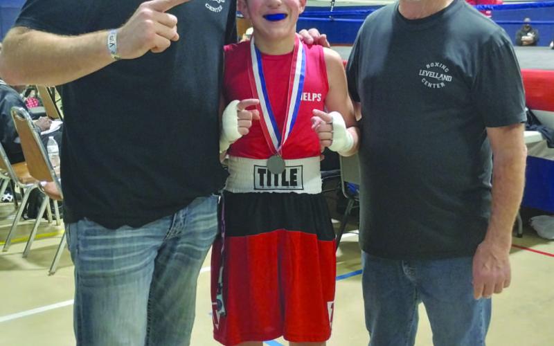 SKILLED BOXING - The Shark Attack Boxing team traveled to Searcy, Arkansas for the Regional Boxing Tournament Dec. 29-31, where Jeremy “Cade” Phelps won advancing to Independence, Missouri Jan. 30 to Feb. 1, for the National Silver Gloves. Pictured is Cade Phelps with Coaches Tray Phelps and Sharkey Lecroy. (Photo courtesy of Sharkey Lecroy)