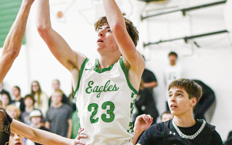 BASELINE JUMPER - Ropes senior guard Cutter Stumbo shoots a baseline jump shot with Sudan defenders surrounding him during their game this past Tuesday night in Ropes. Stumbo would score 15 points in the win. (Staff photo by Jentezen Smith)