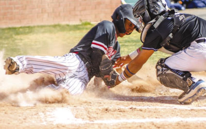 GET DOWN! - Pictured is Levelland Lobo Noah Tienda attempting to beat the tag from the Estacado catcher during Monday’s home game. Suffering a 9-4 loss against the Matadors, the Lobos used the quick turnaround to bounce back and earn their second district win of the season against the Big Spring Steers. Now 2-2 in district play, the Lobos went on the road to face off against the Snyder Tigers Friday. (Staff photo by Dom Puente)