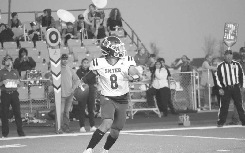 MOBILE - Smyer quarrterback Peyton Casillas made the throw on the run during the teams loss to New Home last Friday during District play. (Staff photo by Aalijah Soliz)