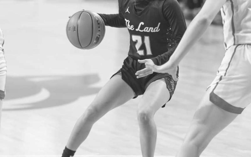 SLIPPERY - Levelland Loboette Carly Tienda looked over the court to read the defense during the team’s final game at ACU this past Tuesday night. (Staff photo by Dom Puente)