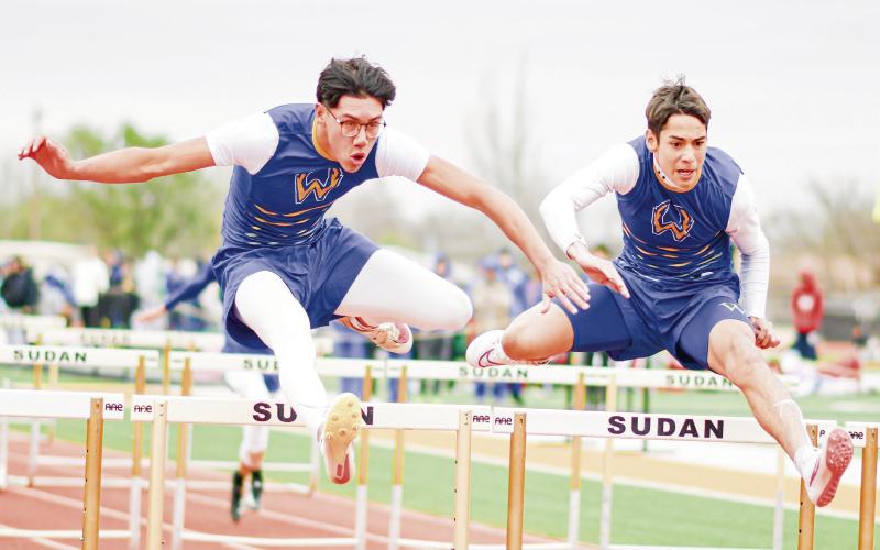 HURDLE BROS - Whiteface Antelope teammates Isaak Soliz (left) and Cesar Chavez (right) hurdle side by side during the 110-meter hurdles at the Son Qualls Relays this past Friday at Sudan High School. Soliz ran a 15.65 in the event and Chavez ran a 15.75. Soliz would also go on to break the 300-meter hurdle school record with a time of 40.07. (Staff photo by Jentezen Smith)