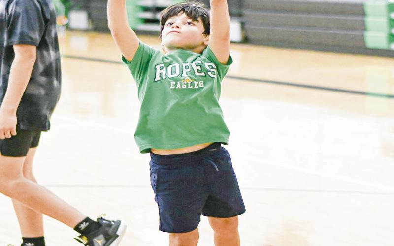 LITTLE MAN LAYUP - Eagle camper Collier Williams shoots a layup during a shooting drill this past Tuesday at the Ropes High School gym. (Staff photo by Jentezen Smith)