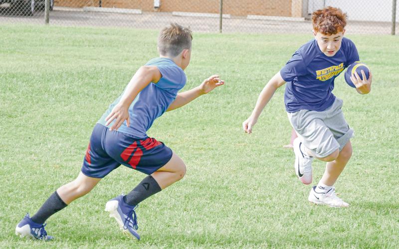 BEAT HIM TO THE OUTSIDE - Antelope camper Eli Maldonado rushes the football and tries to beat defender Guy Anderson to the outside during a tackle pursuit drill at the Whiteface Sports Skills Camp this past Wednesday at Whiteface High School. (Staff photo by Jentezen Smith)