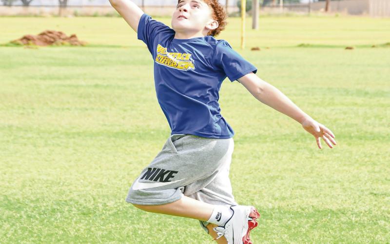 ONE-HANDED ATTEMPT - Antelope camper Eli Maldonado fully extends to attempt to make a one-handed catch during a route running drill at the Whiteface Sports Skills Camp this past Wednesday at Whiteface High School. (Staff photo by Jentezen Smith)