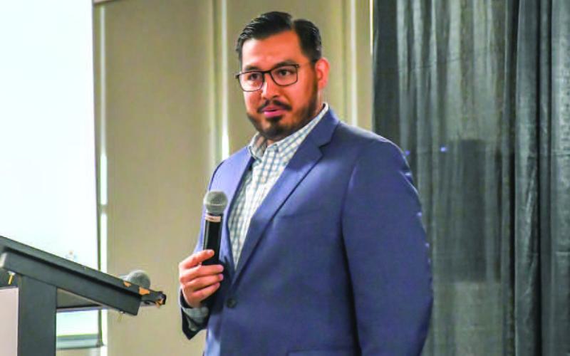 LEDC DIRECTOR - Pictured is Levelland Economic Development (LEDC) Director Justin Balderas introducing keynote speaker Dr. Ray Perryman during the LEDC’s luncheon event held Thursday at the Mallet Event Center and Arena. (Staff photo by Evin Thomas)