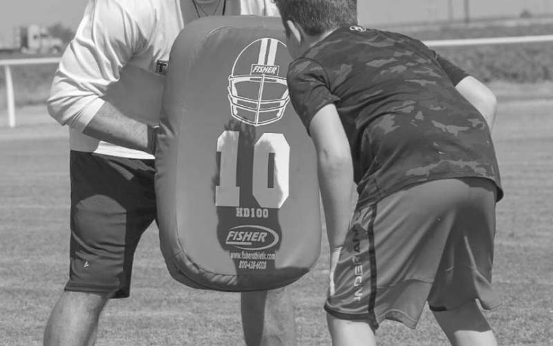 BLOCKING - Whitharral Head Coach Jeremy Holt and Panther Braxton Wecker were going over passing drills with hand placement this past Monday during the Whitharral Allj-Sports Camp. (Staff photo by Aalijah Soliz)