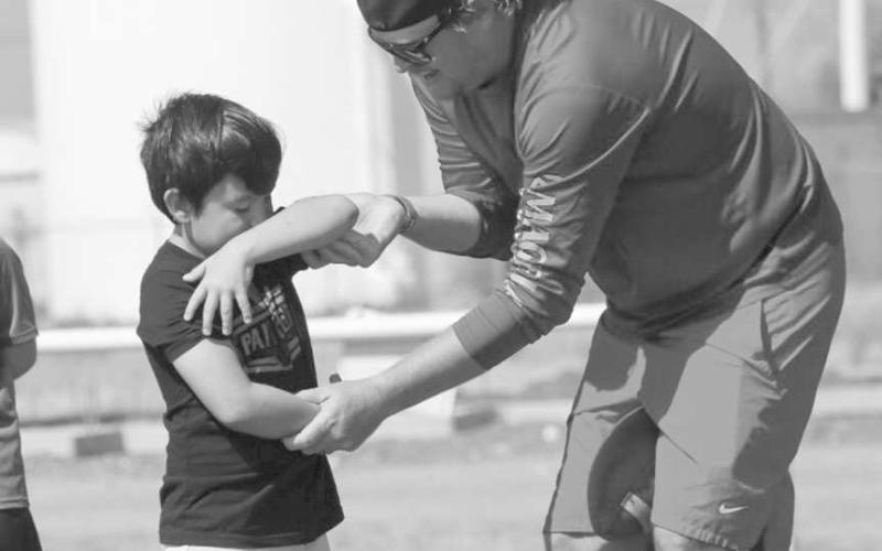 TECHNIQUE - Whitharral Coach Matt White was teaching Panther Virion how to take the hand off from a running play this past Monday at the Whitharral All-Sports Camp. (Staff photo by Aalijah Soliz)