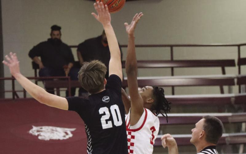TIPOFF - Levelland Lobo Eryk Jones jumped in the tip off to get Levelland the first possession of the game against Bushland during the teams tournament in Littlefield. (Staff photo by Aalijah Soliz)