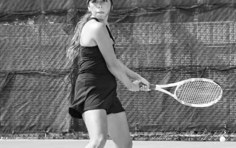 READY TO RESPOND – Daisy Perez gets her racquet and feet in place to make a play on the tennis ball during a match at home against Greenwood this past Tuesday. (Staff photo by Jentezen Smith)