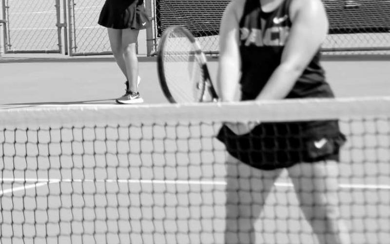 SET &amp;amp; SERVING – Isabel Canales gets set for the play while her doubles teammate Angelina Rivera serves it during a match at home against Greenwood this past Tuesday. (Staff photo by Jentezen Smith)
