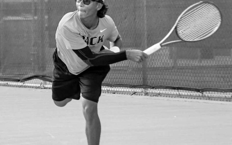 STEP INTO IT – Diego Franco steps into his serve during a match at home against Greenwood this past Tuesday. (Staff photo by Jentezen Smith)