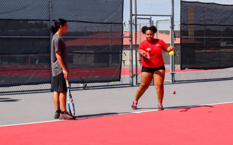 PRACTICE - Levelland athletes Emmina Collins and Jayden Rocha were getting their techniques down during Levelland summer workouts Wednesday. (Staff Photo by Aalijah Soliz)