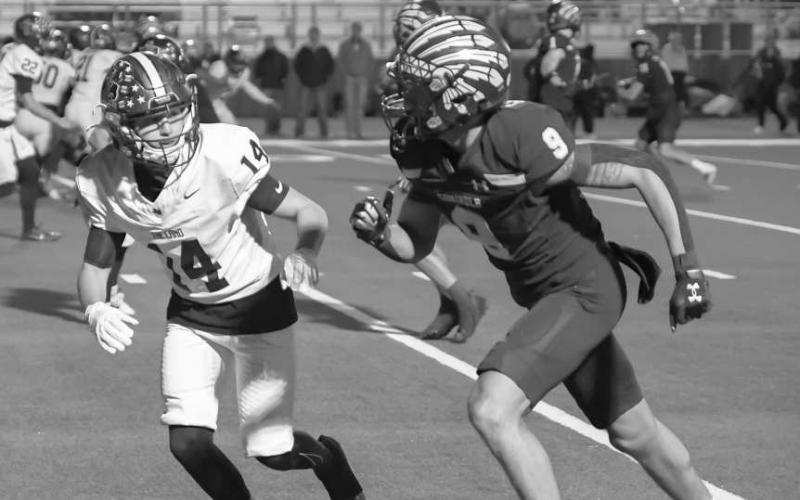 STEP FOR STEP - Levelland Lobo kept up with the Seminole receiver this past Thursday on the road during the team’s playoff game. (Staff photo by Dom Puente)