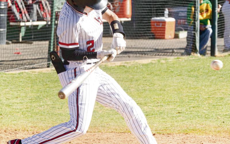 GET YOUR HANDS IN - Levelland Lobo Tobias Gavina gets his hands in to hit an inside pitch during their tournament game against Borger this past Friday at Levelland High School. (Staff photo by Eric Venkatesan)