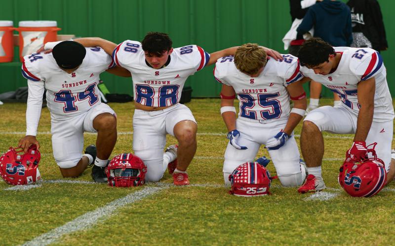 CAPTAINS PRAYER - Sundown football senior team captains kneel down together for a pregame prayer before their game against Ropes this past Friday night at Ropes Eagle Stadium. Pictured from left to right is Joshua Hogan, Toby Lopez, Trevor Bridges and Nathan McAdams. (Staff photo by Jentezen Smith)