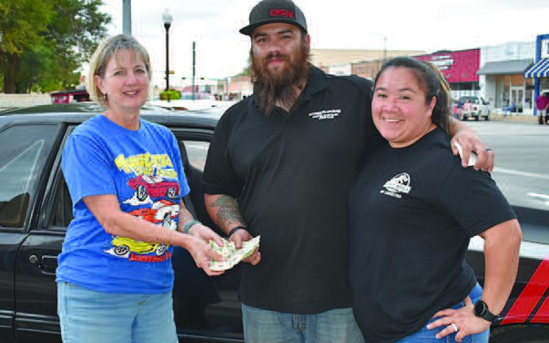 POKER RUN WINNER– AJ and Victoria Hernandez of Levelland, were the big winners of the annual Thunder on the Plains Poker Run held Friday night. The couple took home a $500 cash prize for having 89 poker chip points. Second place winner was DJ and Don Thomas, both received a Thunder on the Plains T-shirt and a dinner voucher for Savannah’s and Swackhammers. There were 100 entries in the 2022 Poker Run. Presenting the award is Thunder on the Plains representative Lindy Williams. (Staff Photo)