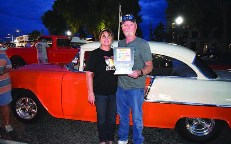 1955 CHEVY-- Orange is the new win for Edith and Tye Taylor of Lovington, New Mexico, with their 1955 2.10 Chevy in the Friday night Thunder on the Plains Poker Run and Cruise. The classic was bought and restored by Tye’s father, the late Mike Taylor. (Staff Photo)