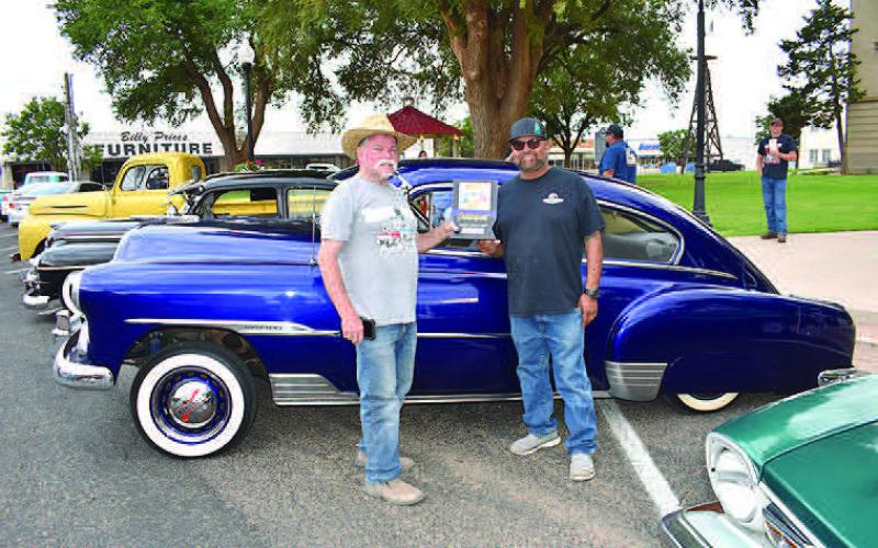 1951 FLEETLINE– Marcus Zapata showed off his 1951 Chevrolet Fleetline in the annual Thunder on the Plains Cruise Friday night. Zapata and his son, Marcus, restored the car together. Thunder on the Plains representative Dyrl Bush presented the award. (Staff Photo)