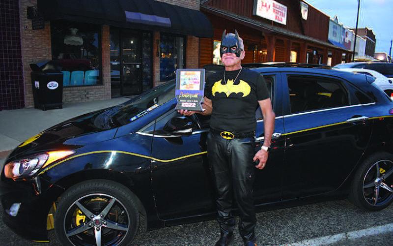 I’M BATMAN– Armando Lee of Levelland, made his appearance as Batman in the annual Thunder on the Plains Poker Run and Cruise Friday night. He received a People’s Choice award for his 2013 Hyundai Elantra GT, painted black and yellow stripped with a Batman logo on the hood. Lee has been appearing as Batman with his “batmobile” in car shows for the past five years. (Staff Photo)