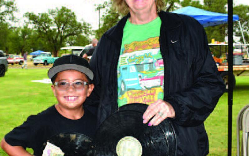 ROCKINGRECORDFLINGWINNER!– The annual Thunder on the Plains held its Rockin Record Fling event Saturday in the City Park. Pictured with Thunder on the Plains representative, Lydia Turner, is first place winner Zade Ruiz, 7. Not pictured is second place winner Matthew Estrada and third place winner Holly Gonzales. The winners of the Rockin Record Fling won a cash prize. (Staff Photo)