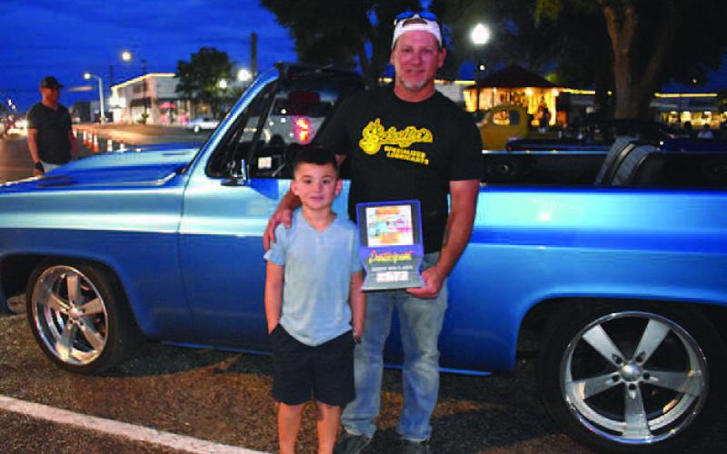 1976 CHEVY BLAZER-- D.J. Champion and his son, Kade, 7, were excited to receive a People’s Choice award at the annual Thunder on the Plains Cruise Friday night. The two brought their 1976 Chevy Blazer from Littlefield for the cruise and classic car show Saturday. (Staff Photo)