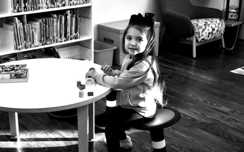 NEVER TO YOUNG TO LEARN- Little Koda Rodriguez could not wait for the New Sundown Library to Open. Here in photo she is siting at one of the new learning tables at the new library where the children can sit and read or play games.(Staff photo by Emily Campos)