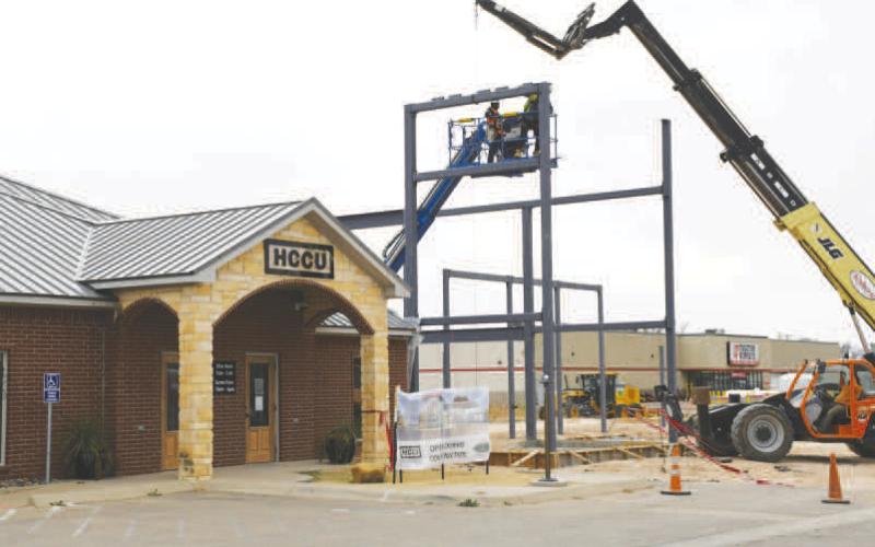 HCCU PROGRESS - Since the ribbon cutting and the ground breaking of what will become the new addition of the Hockley County Credit Union located along Clubview Drive, construction has been ongoing with a focus on dirtwork. Pictured is construction crews placing steel beams this past week next to the current credit union building. (Staff photo by Evin Thomas)