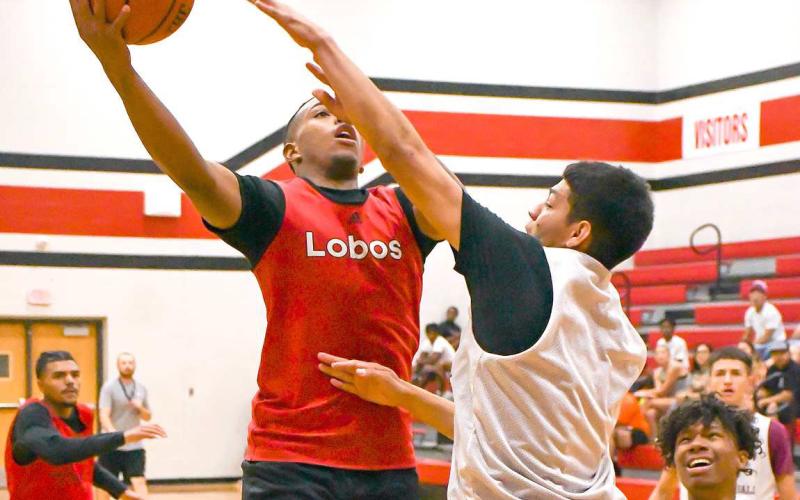 CONTACT FINISH -The Levelland Lobos hosted the Littlefield Wildcats and Canyon Eagles in exhibition matches Thursday at the Levelland Middle School. Pictured is Lobo Jayden Castillo with a tough contact finish in the paint. (Staff Photo by Aalijah Soliz)