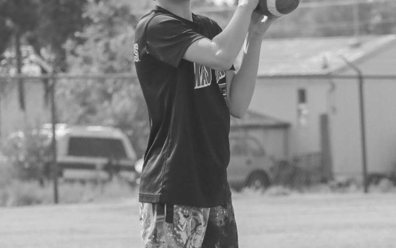 WARM-UPS - Last Thursday at the Morton Football Camp, student-athletes warmed up with throwing the ball to one another. Picutred above is a student catching a pass from another. (Staff photo by Aalijah Soliz)