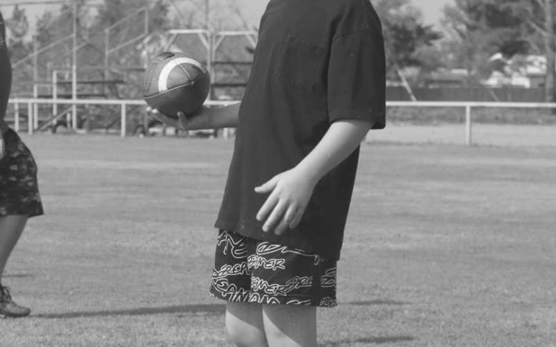 BREATHER - This past Thursday, the Morton Indians hosted their football camp at the Morton Football Field to teach kids more about the sport. Pictured above is a student taking a break in between drills. (Staff photo by Aalijah Soliz)