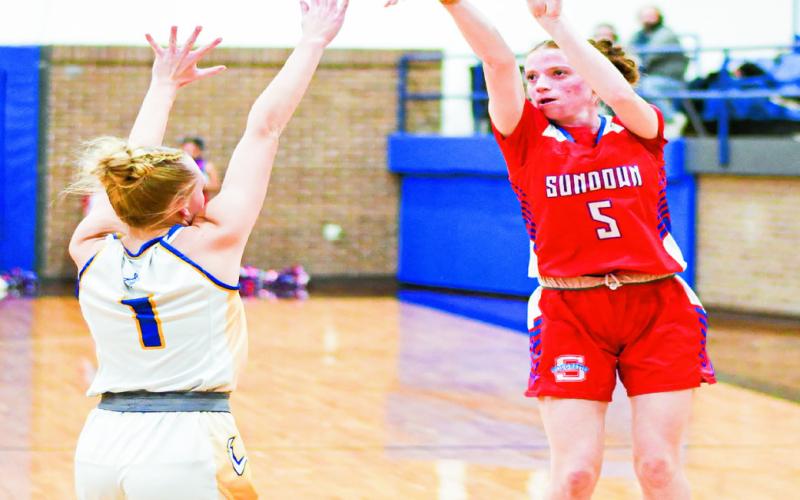 CONTESTED TREY - Sundown’s Camry Jourden shoots a three-pointer while Whiteface’s Emily Blankenship contests it during their game at Whiteface High School this past Tuesday. (Staff photo by Jentezen Smith)