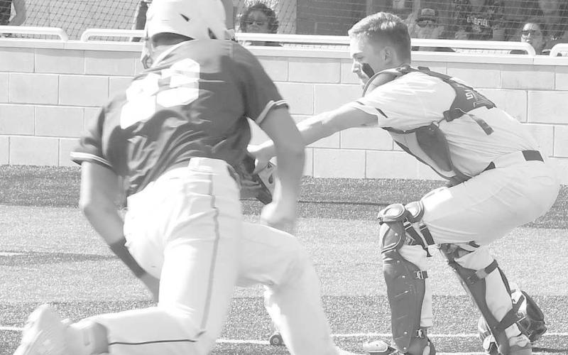 PLAY AT HOME- Smyer catcher Caleb Clausen waited for the ball as Olton’s Brennan Huguley came home in game one of the UIL Class 2A Bi-District Playoff against Olton in Littlefield on Thursday. Clausen got Huguley out, but the Bobcats lost 11-10 and 6-4 in the best of three series. (Photo Courtesy of Jay Kelley)