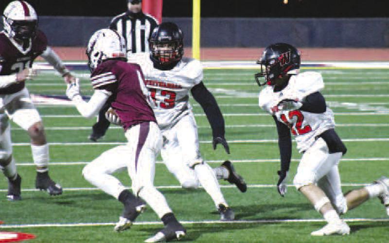 DEFENSIVE PURSUIT- The Whitharral Panthers football team dominated the Klondike Cougars, 64-20, Friday in Lubbock during the area round of playoffs. Whitharral defenders Cason Wischkaemper and Dawson Rodgers pursued a Cougar ball carrier. The Panther will be taking on the Balmorrhea Bears in Hermleigh, Friday at 6 p.m. in the regional finals. (Staff Photo by Dom Puente)