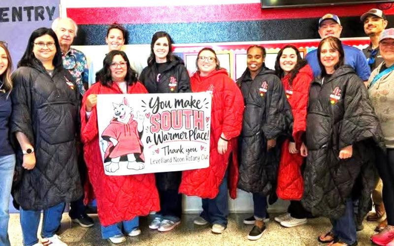 The Levelland Noon Rotary Club donated ponchos to the LISD elementary school personnel who attend to freezing morning duties outside the school during the winter.