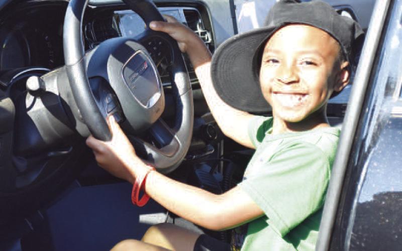 TOUCHATRUCK - Kaydence Childers-Rutherford checks out a Levelland Police Department (LPD) vehicle during Friday’s Touch a Truck event at L.G. Griffin Park, held in conjunction with the Juneteenth celebration. The LPD and several other organizations had vehicles on display. (Staff photo)