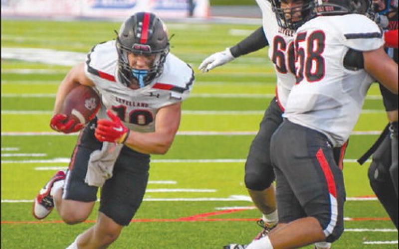 OPEN GAP - Levelland athlete Rusty Johnson ran through the gap that his offensive line made through the Matador defense. The Lobos will face off against San Angelo this Friday as the away team at 7 p.m. (Staff photo by Dom Puente)