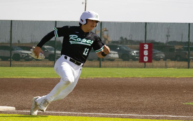 ROUNDING THIRD BASE - Ropes Eagle Zach Ramirez rounds third base during their district baseball against the Sundown Roughnecks this past Friday at Sundown High School. (Staff photo by Eric Venkatesan)