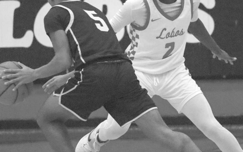 LOCKED DOWN - Levelland Lobo Elijah Jordan locked up his opponent this past Friday during the teams contest against the Snyder Tigers in district play of basketball. (Staff photo by Aalijah Soliz)