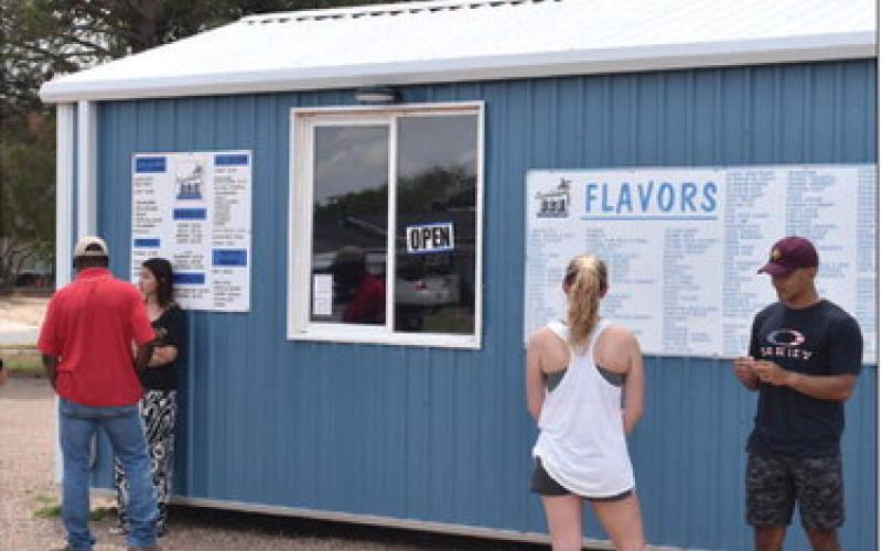 REFRESHING TREAT - Local citizens stopped in for a treat to cool off from the summer weather. (Staff photo by C.R. Calhoun)
